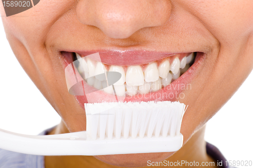 Image of Afro-american girl brushing her teeth