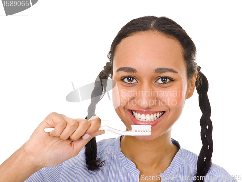 Image of Afro-american girl brushing her teeth