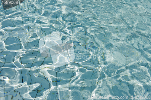Image of Most beautiful clear pool water reflecting in the sun