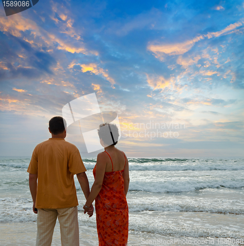 Image of couple on the beach at sunset