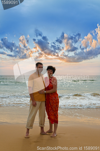 Image of couple on the beach at sunset