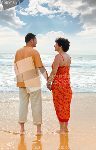 Image of couple on the beach at sunset