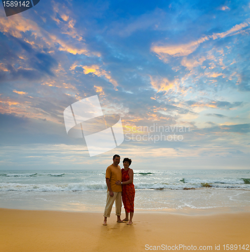 Image of couple on the beach at sunset