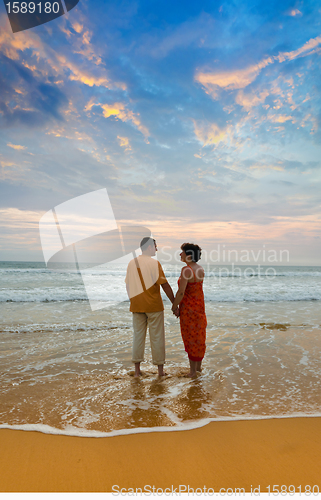 Image of couple on the beach at sunset