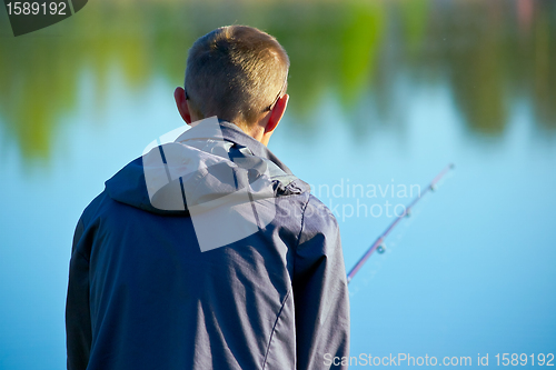 Image of fisher on a morning foggy lake