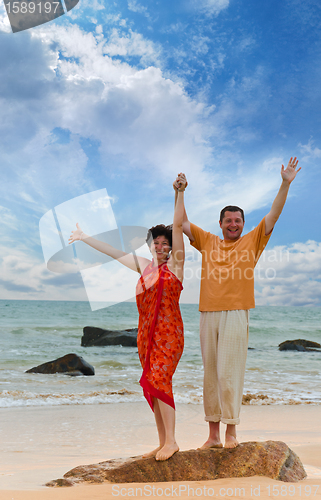 Image of couple on the beach at sunset