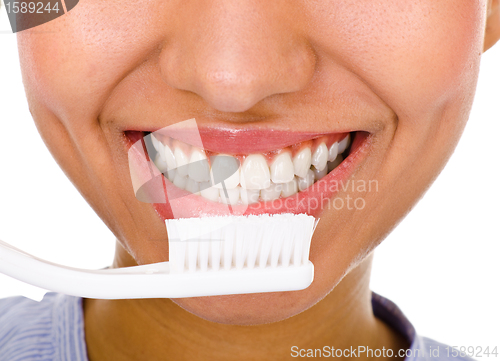 Image of Afro-american girl brushing her teeth