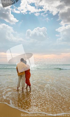 Image of couple on the beach at sunset