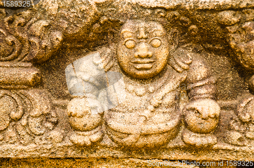 Image of stone statues that support the arch of steps, leading to a holy 