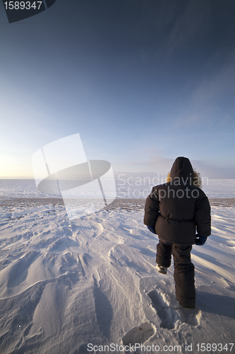 Image of walking boy in snow