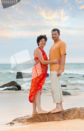 Image of couple on the beach at sunset