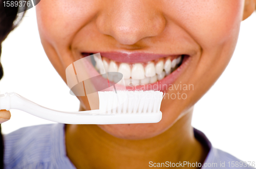 Image of Afro-american girl brushing her teeth