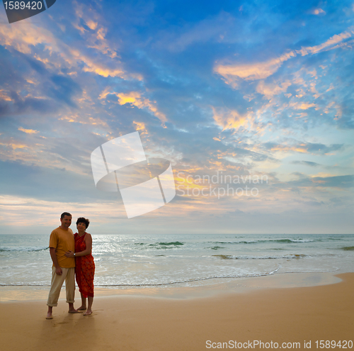 Image of couple on the beach at sunset