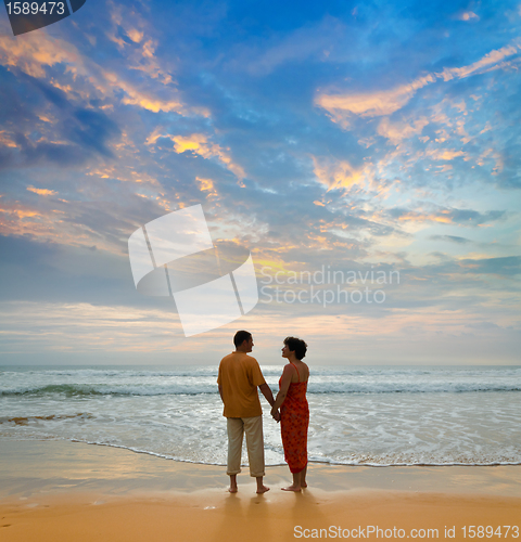 Image of couple on the beach at sunset