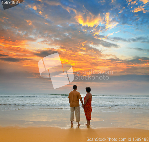 Image of couple on the beach at sunset