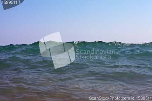 Image of silhouette of a sea wave in the sky
