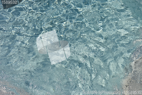 Image of beautiful clear pool water reflecting in the sun