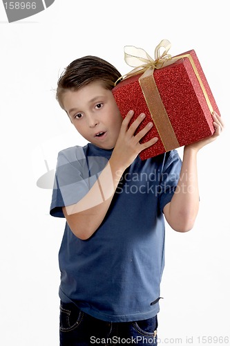 Image of Child shaking a wrapped present