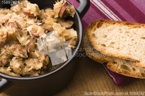 Image of traditional polish sauerkraut (bigos) with mushrooms and plums