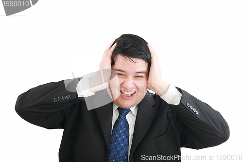 Image of Frustrated young businessman pulling his hair, studio shot 