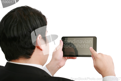 Image of Businessman holding a blank touchpad pc, one finger touches the 