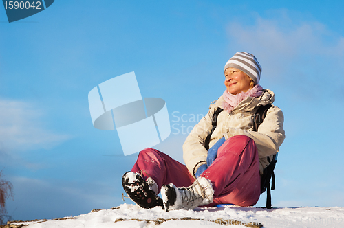 Image of woman sitting outdoors and enjoy the Sun