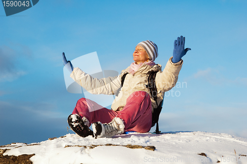 Image of woman sitting outdoors and enjoy the Sun