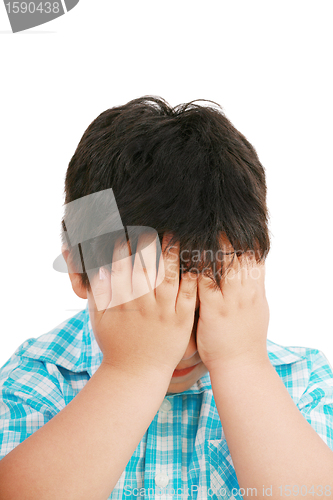 Image of Very cute little boy with sad expression and hands on face 