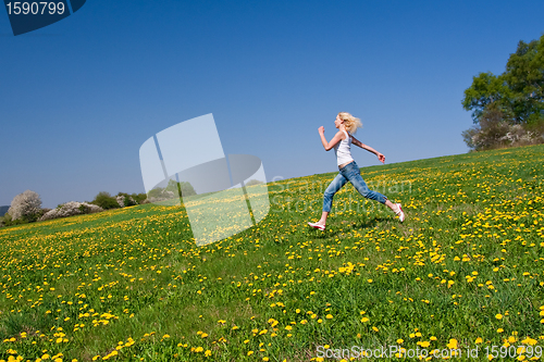 Image of happy young woman on meadow