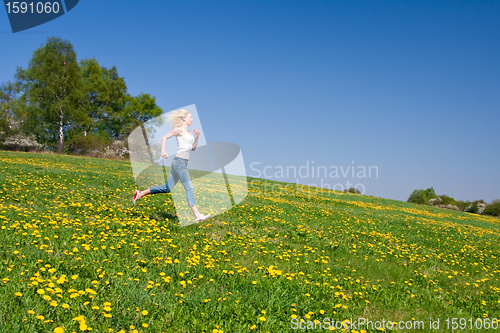 Image of happy young woman on meadow