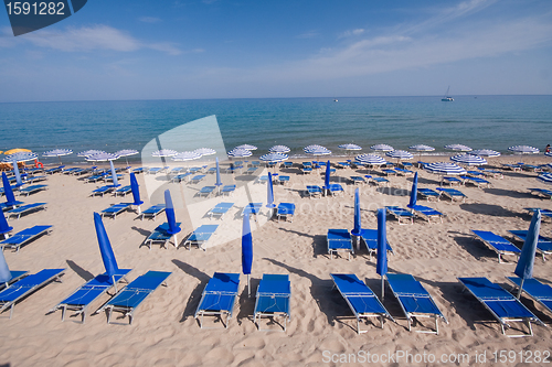 Image of beach with chairs and umbrellas