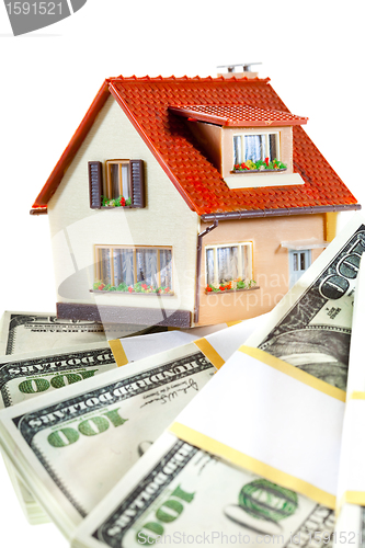 Image of house on packs of banknotes