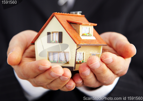 Image of Hand of the businessman with the house