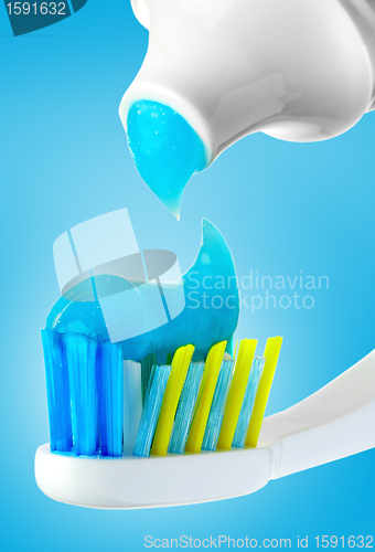 Image of Dental brush and tube with paste.