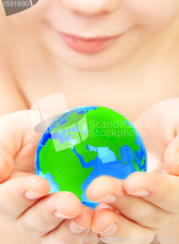 Image of boy holds globe in hands