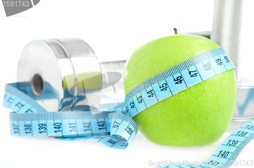 Image of Dumbbells and apple. A healthy way of life