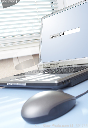 Image of Computer on a table. Search of work.