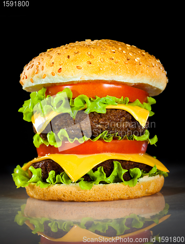 Image of Tasty and appetizing hamburger on a dark