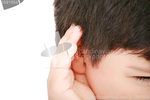 Image of A little boy trying to hearing the sound around him - What did y