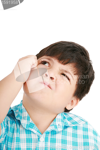 Image of boy looking up and scratches his head, isolated on white