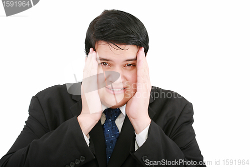 Image of Close-up of a businessman with a migraine holding his temples.