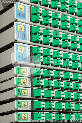 Image of fiber optic rack with high density of blue and green SC connectors