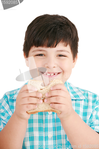 Image of Little boy eating a integral bread, sandwich. isolated on a whit