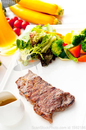 Image of juicy BBQ grilled rib eye ,ribeye steak and vegetables