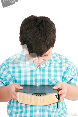 Image of portrait of a boy with a Bible in hand  and prayed