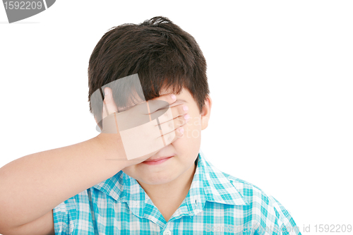 Image of portrait of sad crying little boy covers his face with her hand