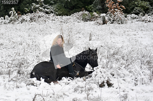 Image of girl and horse in snow