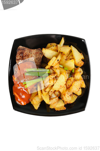 Image of Grilled meat and  fried  potatoes  on a plate