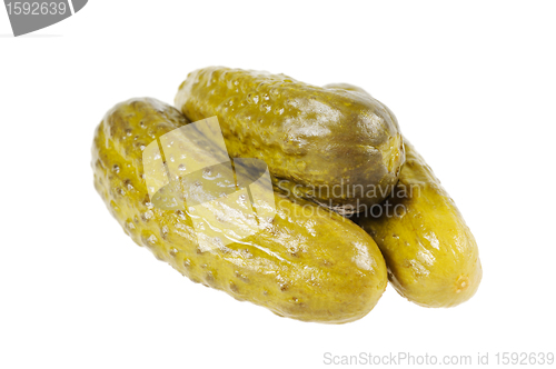 Image of Three pickled  cucumbers.  Gherkins.