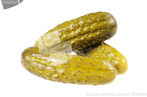 Image of Three pickled  cucumbers.  Gherkins.